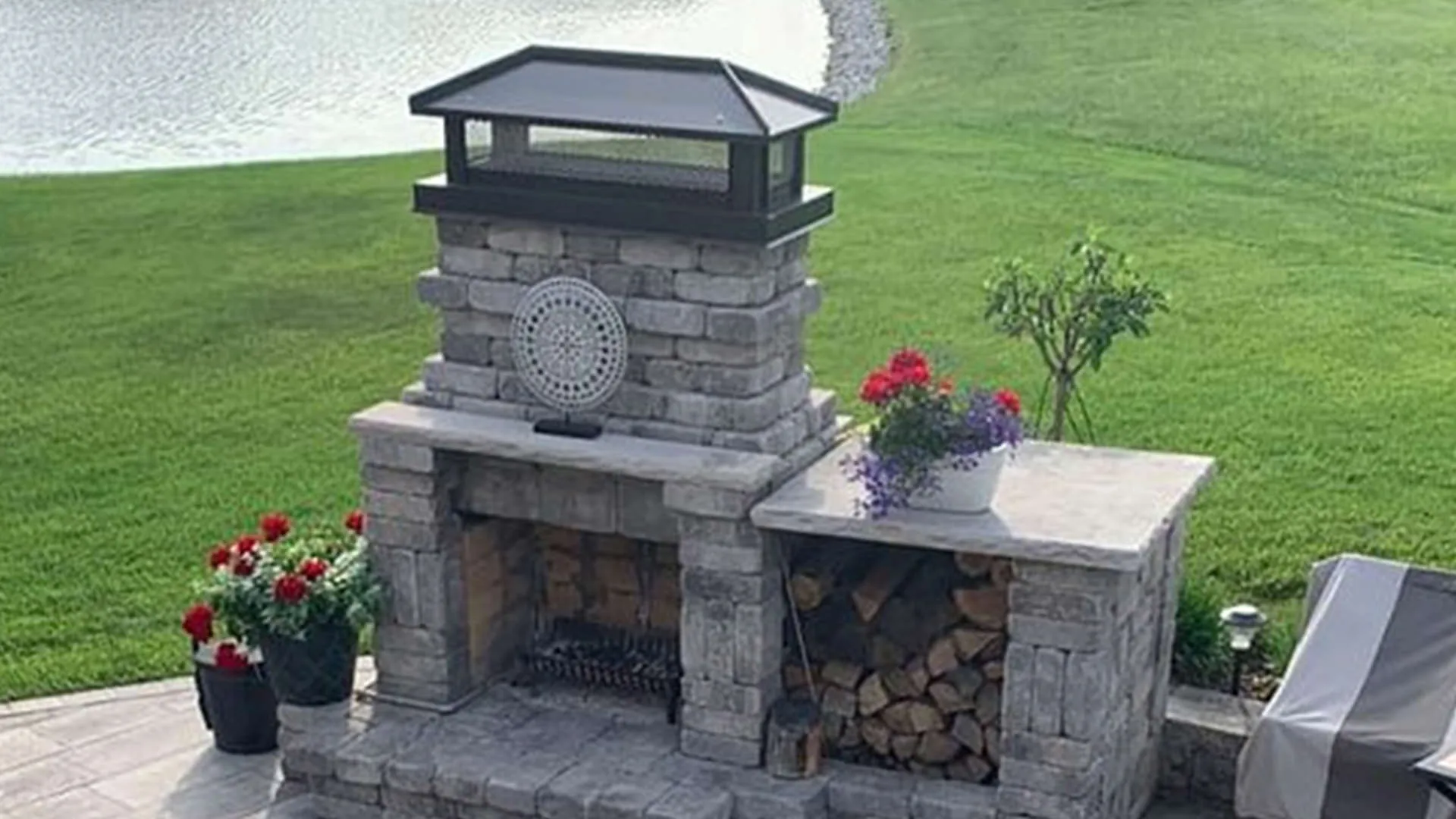 Hip-and-ridge chimney cap installed on an outdoor fireplace