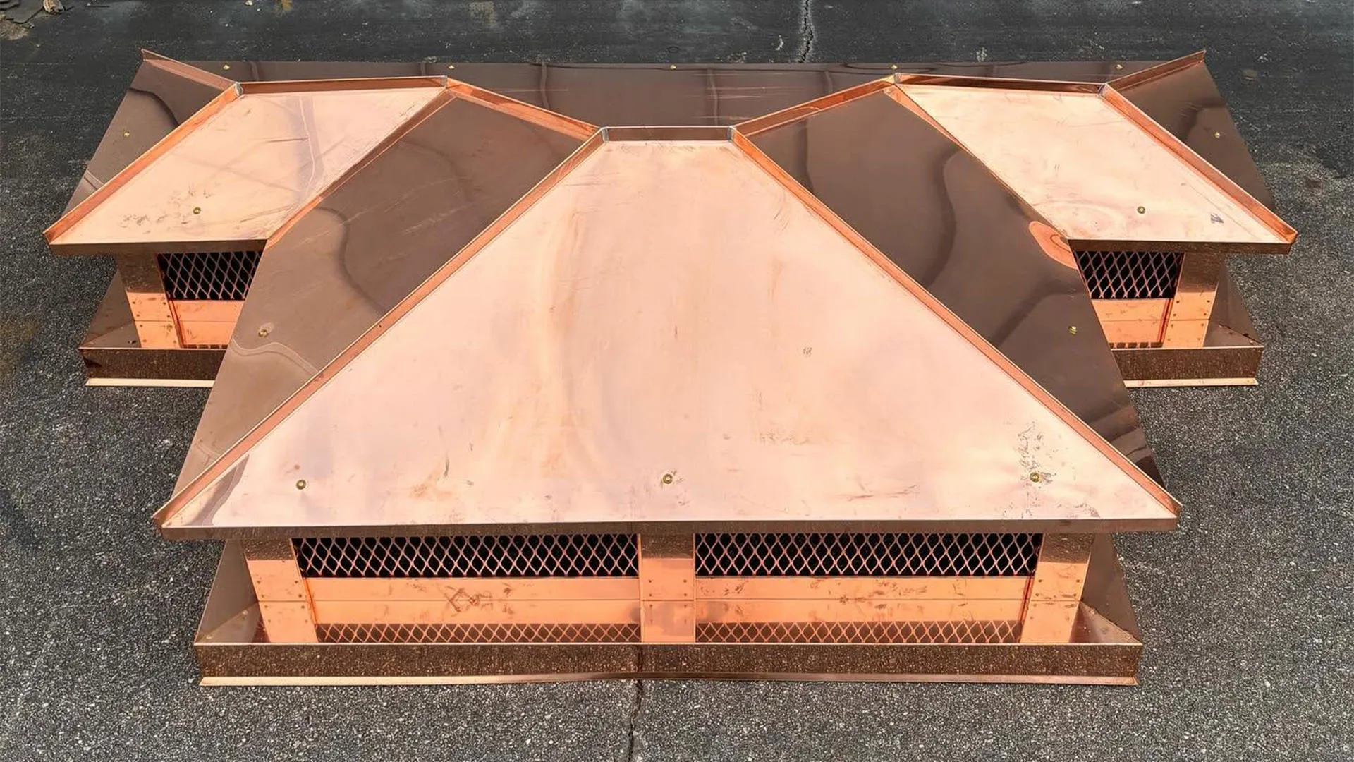 Custom copper hip-and-ridge chimney cap