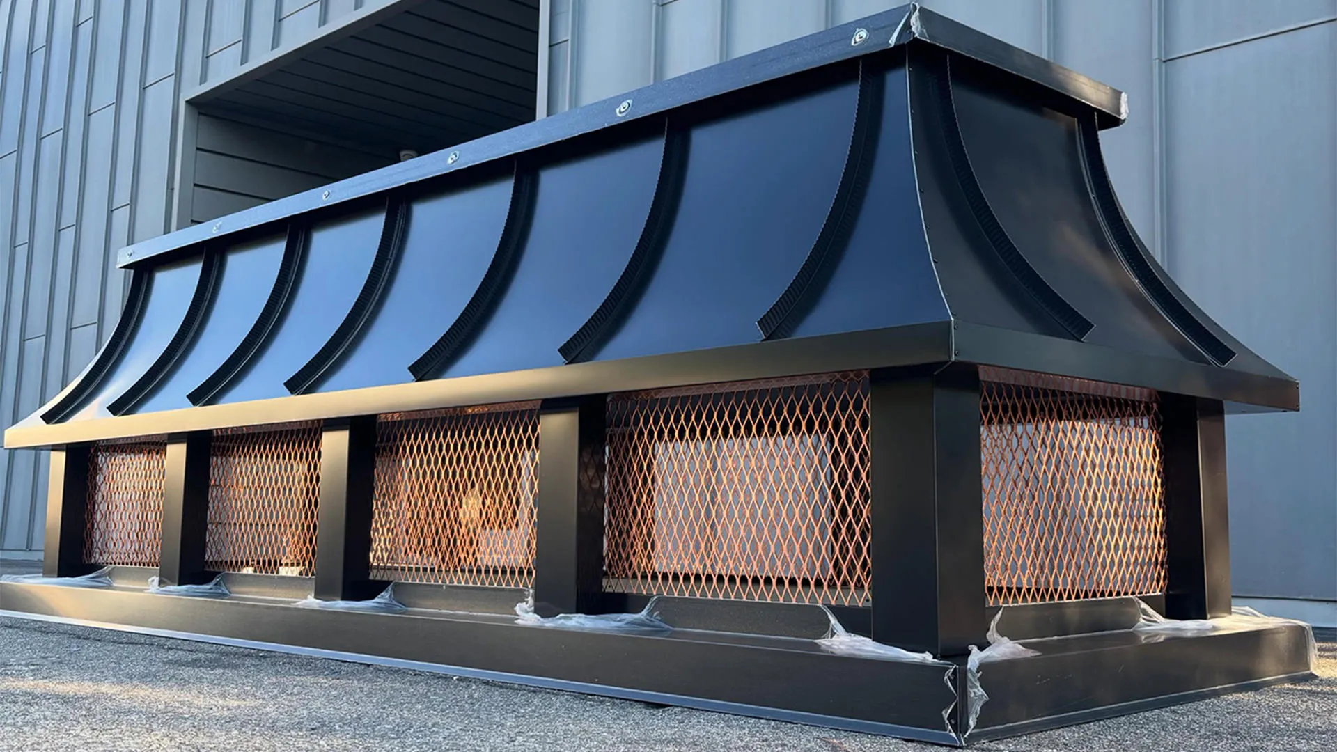 Black Kynar-finished aluminum chimney cap with copper screen