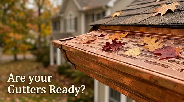 Copper K-style gutter with a copper gutter screen and autumn leaves