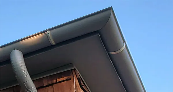 Galvalume half-round gutter miter joining gutter sections at a corner