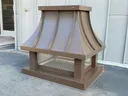 Dark bronze aluminum concave standing seam radius roof chimney cap